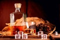 Glass of whiskey with ice decanter on wooden table Royalty Free Stock Photo