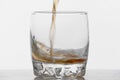 Glass of whiskey with ice isolated on white background Royalty Free Stock Photo