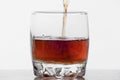 Glass of whiskey with ice isolated on white background Royalty Free Stock Photo