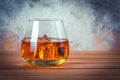 Glass of whiskey with ice. Still life. Brandy, bourbon on a brown wooden table. Strong alcohol drink. Rum, scotch. Copy space for Royalty Free Stock Photo
