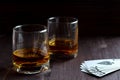 Glass of whiskey with ice on a wooden background. Royalty Free Stock Photo