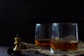 Glass of whiskey with ice on a wooden background. Royalty Free Stock Photo