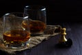 Glass of whiskey with ice on a wooden background. Royalty Free Stock Photo