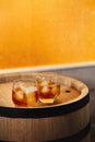 Glass of whiskey on wooden background close up