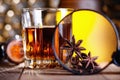 Glass of whiskey, magnifying glass, anise and cinnamone Royalty Free Stock Photo