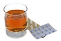 Glass of whiskey next to blister packs of drugs on white background Royalty Free Stock Photo
