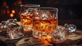 Glass of whiskey on an old wooden table. Alcohol drink, splash, ice cube Royalty Free Stock Photo