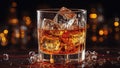 Glass of whiskey on an old wooden table. Alcohol drink, splash, ice cube Royalty Free Stock Photo