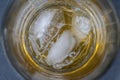 Glass with whiskey on the rocks as background in detail Royalty Free Stock Photo
