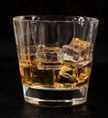 Glass of whiskey on the rocks Royalty Free Stock Photo