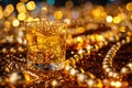 A glass of whiskey on the rocks, surrounded by golden and silver beads, set against an abstract background with bokeh lights. The Royalty Free Stock Photo