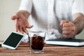 A glass of whiskey or rum on the office desk Royalty Free Stock Photo