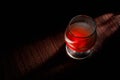 Glass of whiskey with smoking cigar and ice cubes on wooden table wine, luxury