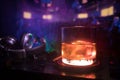 Glass with whisky with ice cube inside on dj controller at nightclub. Dj Console with club drink at music party in nightclub with Royalty Free Stock Photo