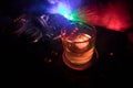 Glass with whisky with ice cube inside on dj controller at nightclub. Dj Console with club drink at music party in nightclub with Royalty Free Stock Photo