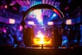 Glass with whisky with ice cube inside on dj controller at nightclub. Dj Console with club drink at music party in nightclub with