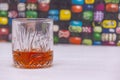 A GLASS OF WHISKY SHOT ON A COLORFUL BACKGROUND Royalty Free Stock Photo