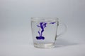 Glass on white background with blue color paints inside