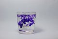 Glass on white background with blue color paints inside