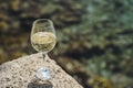 Glass of white wine against the background of the Mediterranean beach and the sea in a tourist town in the summer under Royalty Free Stock Photo