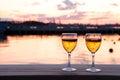 Glass of white wine against sunset. Beautiful summer evening sea view Royalty Free Stock Photo