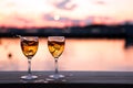 Glass of white wine against sunset. Beautiful summer evening sea view Royalty Free Stock Photo