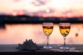Glass of white wine against sunset. Beautiful summer evening sea view Royalty Free Stock Photo