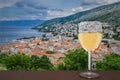 Glass of white wine against view from above on Senj town, Croatia. View from Nehaj Fortress, fort on the hill, Velebit, Croatia Royalty Free Stock Photo