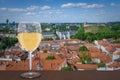 Glass of white wine against Vilnius city center. Vacation concept. View from above of St. Stanislaus Cathedral on Cathedral Square Royalty Free Stock Photo