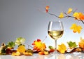 Glass of white wine and autumn leaves on a light gray background. Copy space Royalty Free Stock Photo