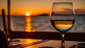 Glass of white wine on the background of the sea and sunset. Royalty Free Stock Photo