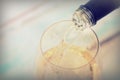 Glass of white wine being poured from bottle Royalty Free Stock Photo