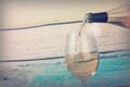 Glass of white wine being poured from bottle Royalty Free Stock Photo