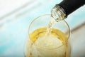 Glass of white wine being poured from bottle Royalty Free Stock Photo