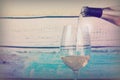 Glass of white wine being poured from bottle Royalty Free Stock Photo