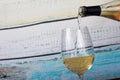 Glass of white wine being poured from bottle Royalty Free Stock Photo