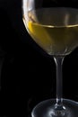 A glass of white wine on black background Royalty Free Stock Photo