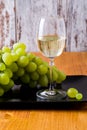Glass of white wine and a bunch of grapes. Royalty Free Stock Photo