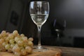 Glass of white wine and bunch of grapes on a wooden table. With copy space for text. Royalty Free Stock Photo