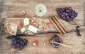 Glass of white wine, cheese board, grapes, figs, strawberries, honey and bread sticks on rustic wooden background Royalty Free Stock Photo