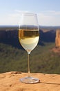 Glass of white wine on cliff edge. Australian wine concept. Royalty Free Stock Photo