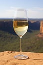 Glass of white wine on cliff edge. Australian wine concept.