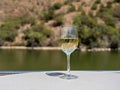 Glass of white wine on a cruise boat on Douro river in Portugal Royalty Free Stock Photo