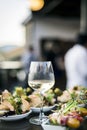 Glass of white wine with gourmet food tapa snacks outside