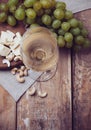 Glass of white wine, grapes, cashew nuts and soft cheese Royalty Free Stock Photo