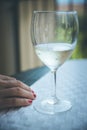 Drinking problem: Glass of white wine, hand of a woman with red nail polish Royalty Free Stock Photo