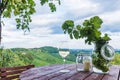 Glass white wine and jars with grapes and candle on wooden barre Royalty Free Stock Photo