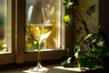 A glass of white wine placed on a windowsill, perfect for a quiet evening or a cozy atmosphere Royalty Free Stock Photo