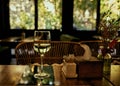A glass of white wine on a restaurant table with a reflection of the interior in it Royalty Free Stock Photo