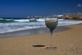 Glass of white wine on the seashore against a blue sky. Royalty Free Stock Photo